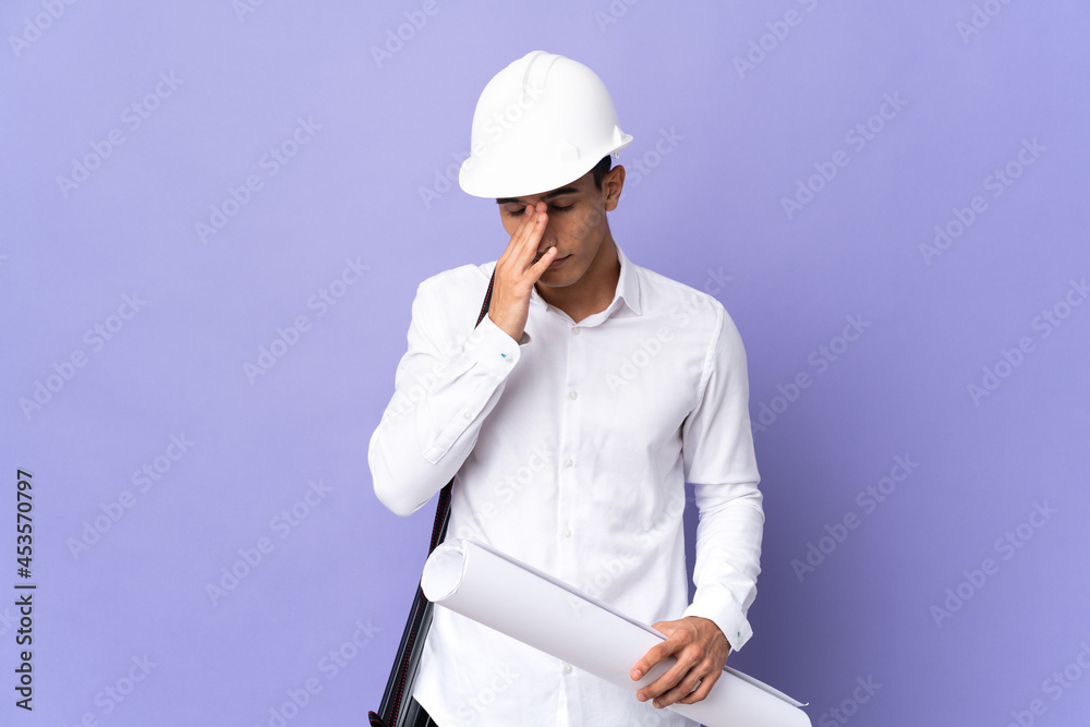 Young architect man isolated on background with tired and sick expression Young architect man isolated on background with tired and sick expression