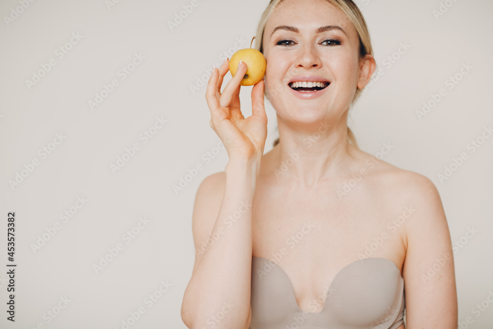 Young lovely woman with apple near face, skin natural care cosmetics concept