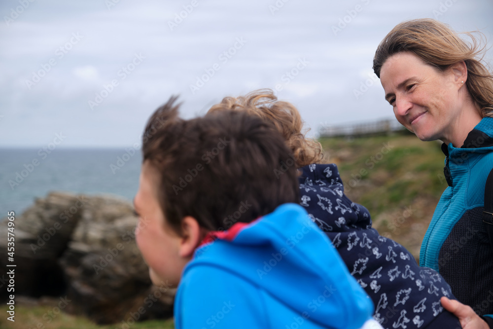 Children with their mother looking out over the sea from a lookout point. Children with their mother looking out over the sea from a lookout point. Children with their mother looking out over the sea from a lookout point. Children with their mother looking out over the sea from a lookout point.