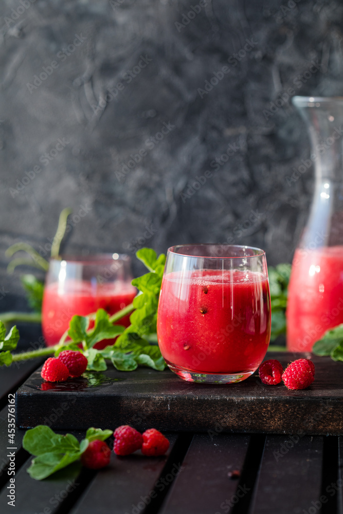 Summer drink. Cold watermelon drink with lime and mint on a wooden board. Berry-fruit smoothie. Summer drink. Cold watermelon drink with lime and mint on a wooden board. Berry-fruit smoothie.