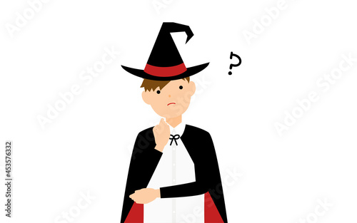 ハロウィンの仮装、魔法使い姿の男の子が腕組みして悩むポーズ