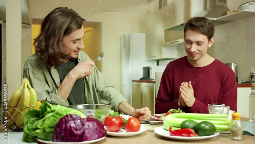 Two men are having meal together 