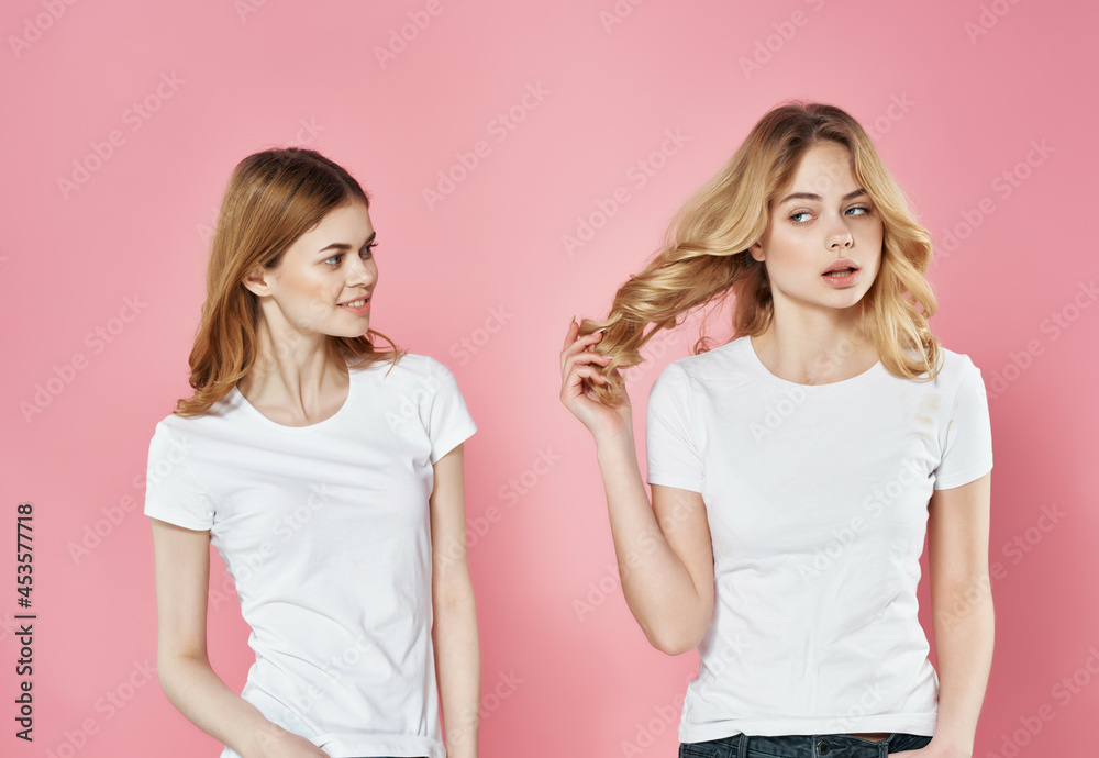 two cute girlfriends in white t-shirts emotions friendship fashion two cute girlfriends in white t-shirts emotions friendship fashion