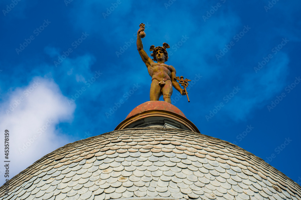 Obraz premium Statue of Mercury on top of the roof of a building in Novi Sad, Serbia