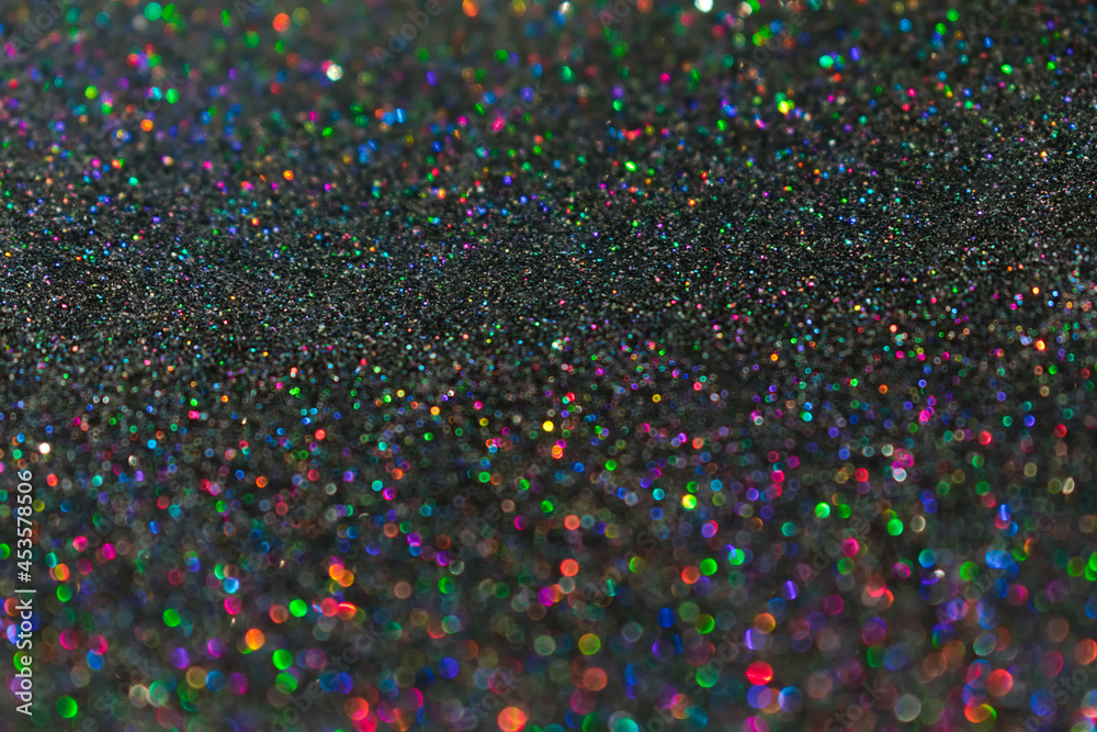 Colorful twinkle blurred glitter background. Abstract festive background with bright lights