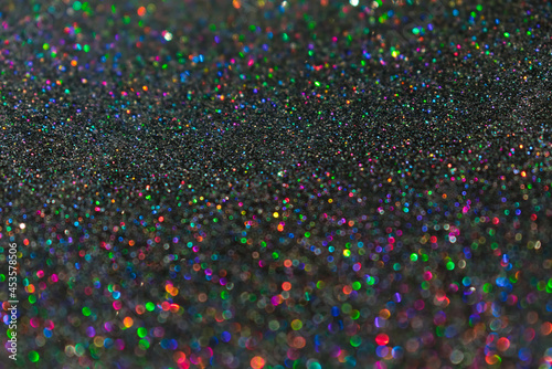 Colorful twinkle blurred glitter background. Abstract festive background with bright lights 