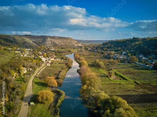 Orheiul Vechi hills and river scenery in Moldova . Valley of river Raut in villages Butuceni and Trebujeni from Moldova . Famous touristic place . Church on the top on the hill photo
