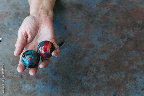 hands of senior adult woman excercising with chinese baoding balls for stress relief and deep relaxation photo