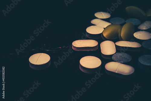 Pharmaceutical medicine pills in both tablets and capsules with the vintage retro picture style. Pharmacy theme and treatment medication as concept.	