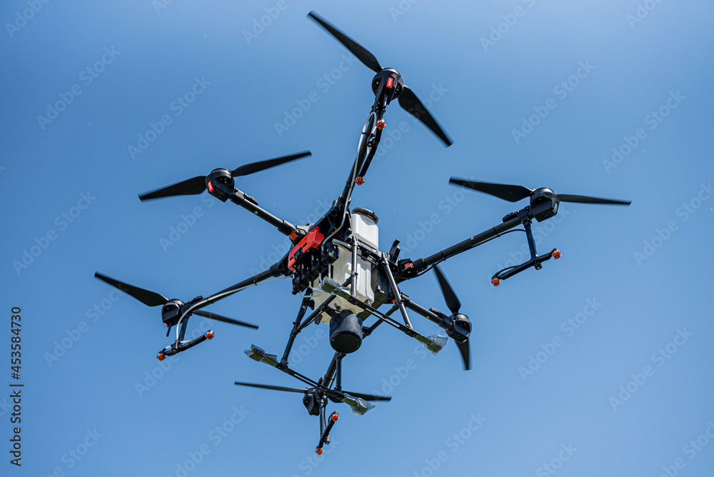 Professional agriculture drone flying in the blue sky