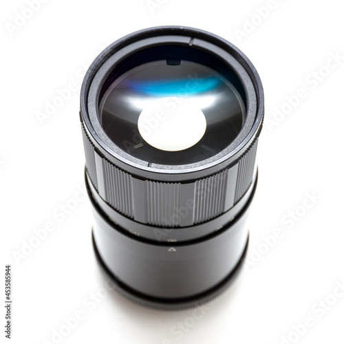 Frpmt view of a soviet era mirror tele lens. Macro studio shot on white background photo