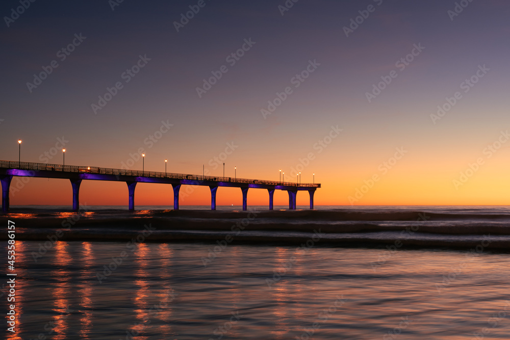 New Brighton Pier during colorful sunrise morning. Christchurch city, New Zealand