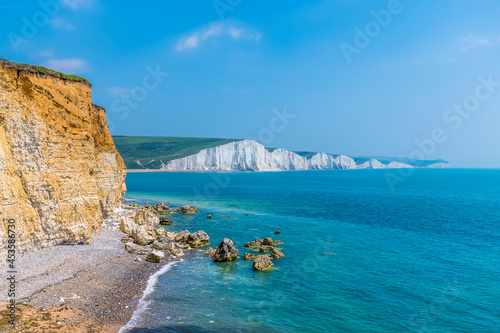 A view from Hope Gap, Seaford along the cliff edge towards the Seven Sisters Chalk cliffs, UK in early summer