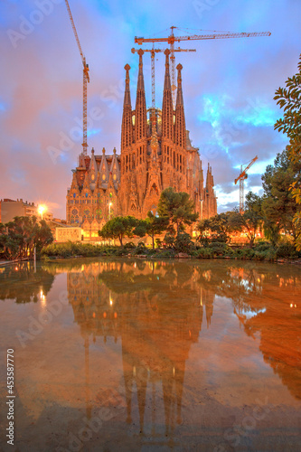 The Sagrada Familia at dusk reflected in the water, Barcelona, Spain