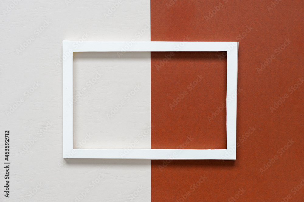 Fototapeta premium white paper frame on dark brown paper and beige paper.