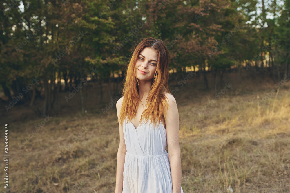 pretty woman in white dress walks in nature in the field freedom pretty woman in white dress walks in nature in the field freedom