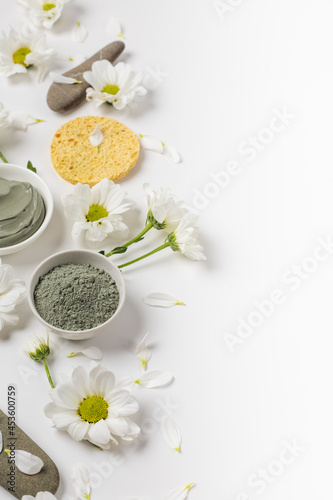 Natural clay mask dry and wet with flowers on a white background