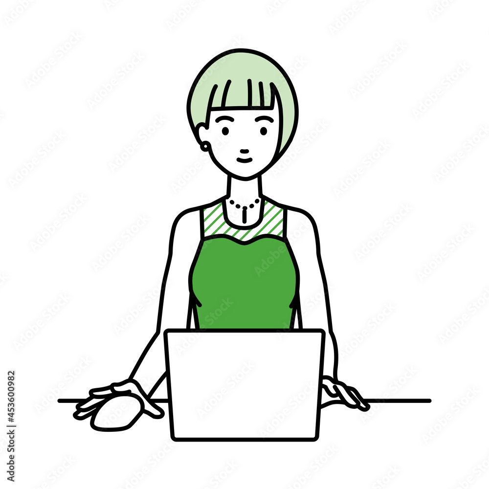 デスクで座ってPCを使っているドレスの女性 デスクで座ってPCを使っているドレスの女性