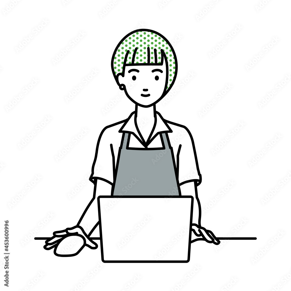 デスクで座ってPCを使っているカフェ店員の女性 デスクで座ってPCを使っているカフェ店員の女性