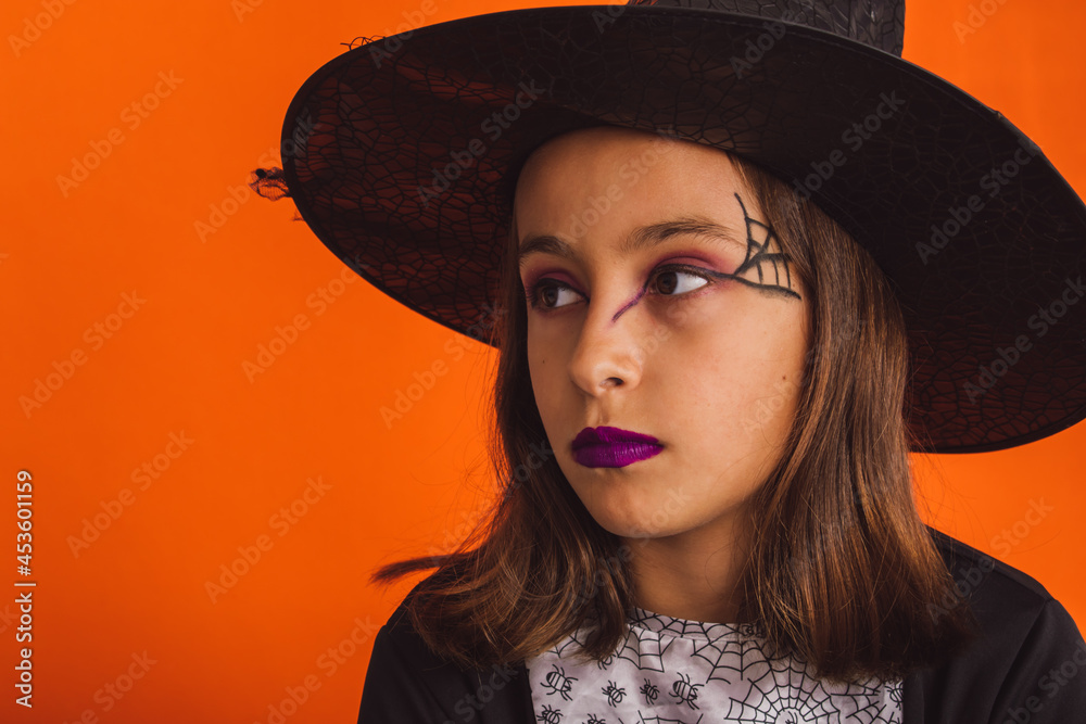 Portrait of a little witch with serious gesture on Halloween Portrait of a little witch with serious gesture on Halloween
