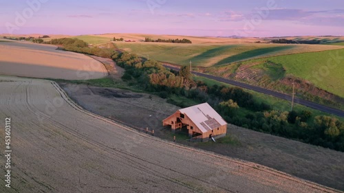 Aerial: Wheat fields and old barn at sunset, Pullman, Washington, USA