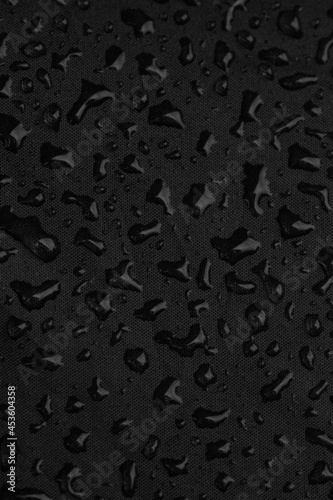 close up of raindrops on black background, macro