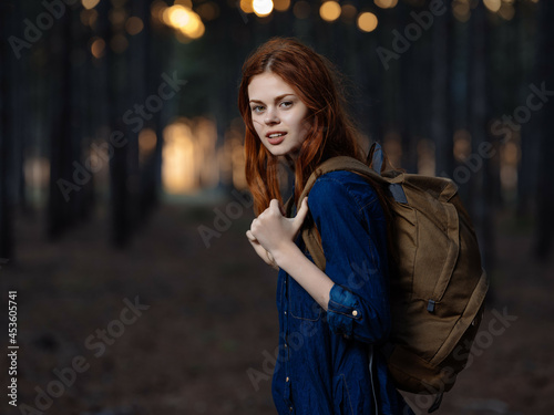 woman hiker backpack travel in the forest freedom