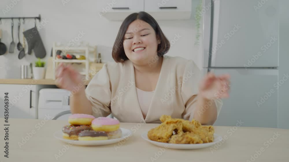 Asian young oversize big women feel happy for unhealthy foods on plate Asian young oversize big women feel happy for unhealthy foods on plate