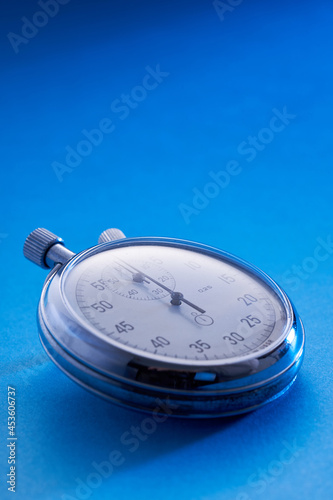 close up of stopwatch on blue background