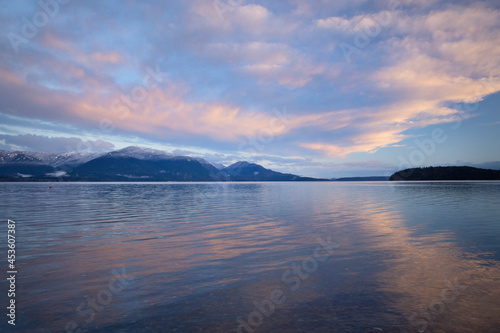 Sunrise in the Pacific Northwest over the Olympic Mountains with fresh snow in the hills and early morning light