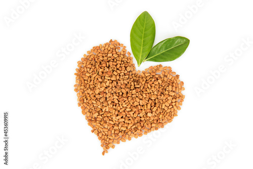 Fenugreek  seeds arranged heart shape isolated on white background.top view,flat lay. photo