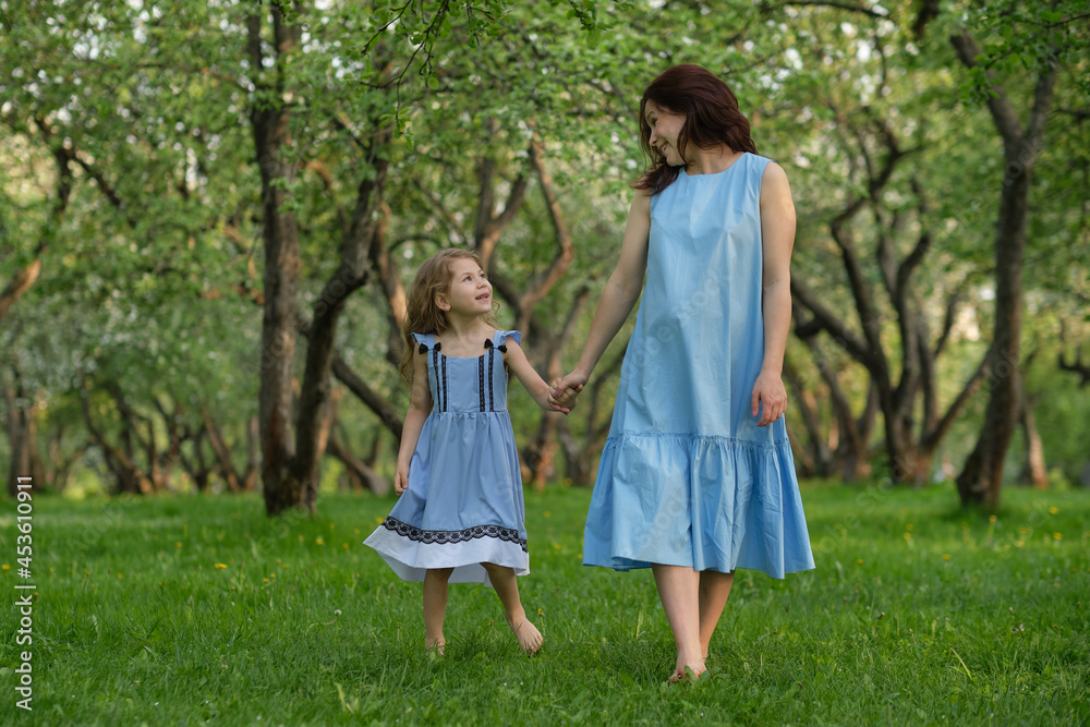 mother and child having fun in the park. Mother and little daughter playing together in a park. Happy family concept.