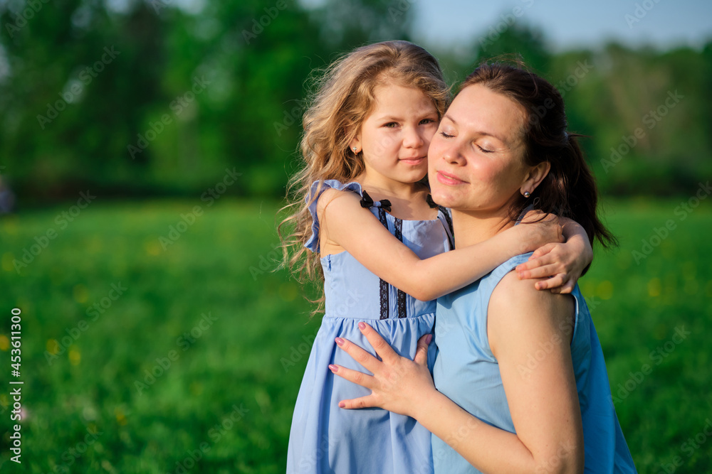 nature scene with family outdoor lifestyle. Mother and little daughter playing together in a park. Happy family concept. Happiness and harmony in family life. nature scene with family outdoor lifestyle. Mother and little daughter playing together in a park. Happy family concept. Happiness and harmony in family life.