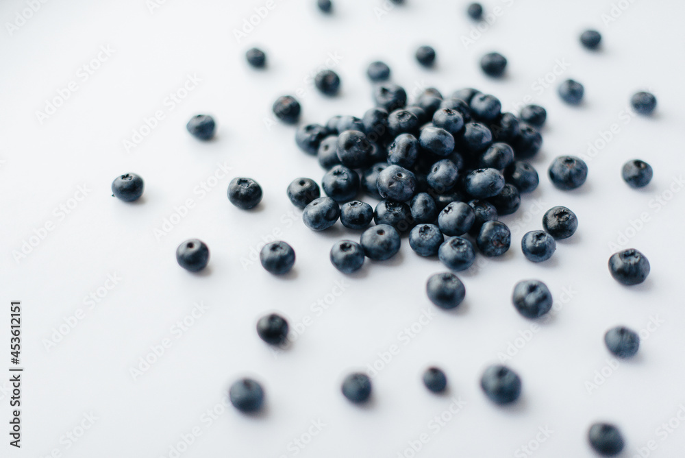 A bunch of ripe, beautiful blueberries, blueberries close-up on a white background. Healthy food, and vitamins. A bunch of ripe, beautiful blueberries, blueberries close-up on a white background. Healthy food, and vitamins.