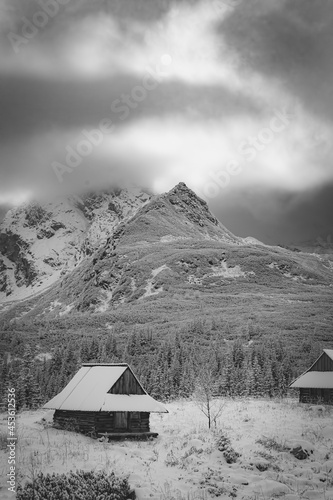 Fototapeta Naklejka Na Ścianę i Meble -  Dramatic mood in Hala Gąsienicowa Valley, High Tatra Mountains, Poland. Black and white winter failytale. Selective focus on the summit, blurred background.