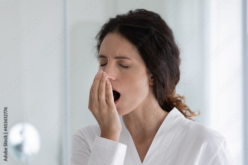 Sleepy young hispanic woman holding hand near mouth, checking breath freshness, worrying about effective oral hygienic routine, having problems with caries gingivitis, dentistry healthcare concept. Sleepy young hispanic woman holding hand near mouth, checking breath freshness, worrying about effective oral hygienic routine, having problems with caries gingivitis, dentistry healthcare concept.