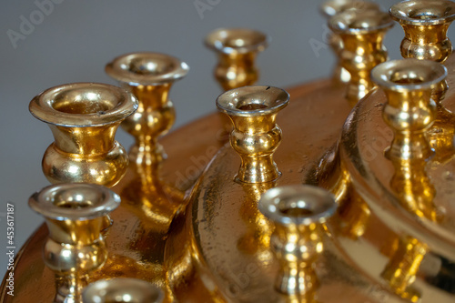 A large brass candlestick without candles standing in an Orthodox church. The interior of the church. A place for prayer and repentance.