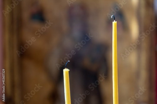 Two extinguished candles close-up in an Orthodox church. The interior of the church. A place for prayer and repentance. photo