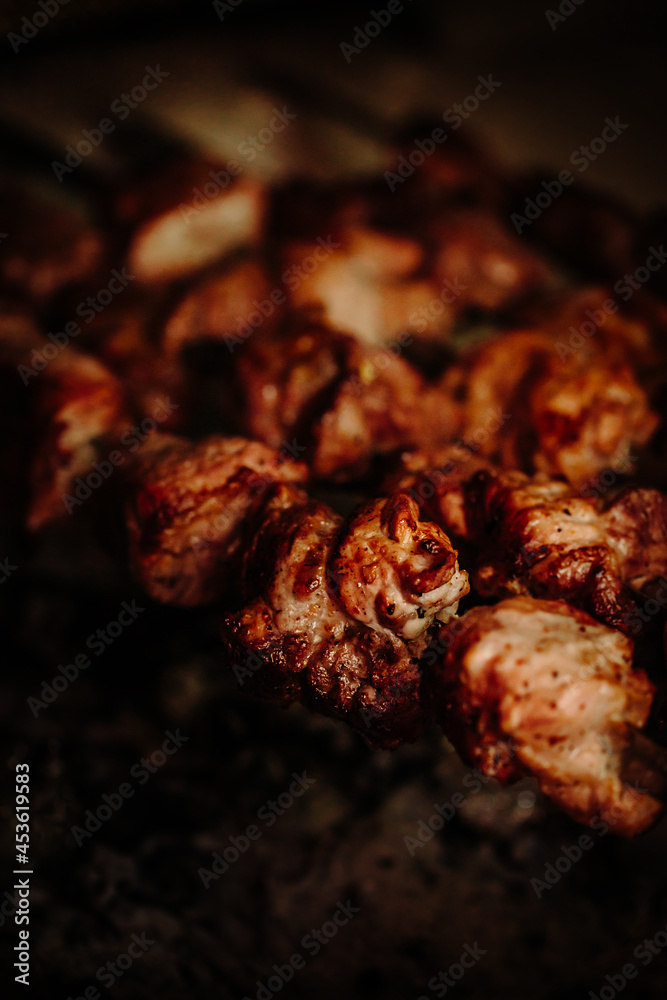 beef pork shish kebabs roasting on the grill closeup. smoky meat, bbq party. outdoor recreation, vacation. vertical photo beef pork shish kebabs roasting on the grill closeup. smoky meat, bbq party. outdoor recreation, vacation. vertical photo