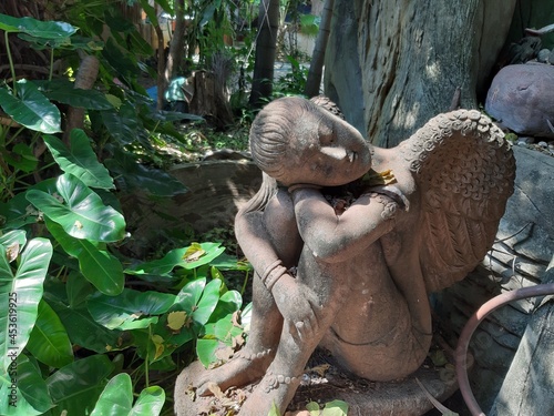 statue of angel with a flower
