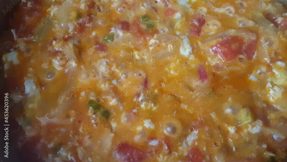 Menemen dish made with onions, peppers, tomatoes and eggs Menemen dish made with onions, peppers, tomatoes and eggs