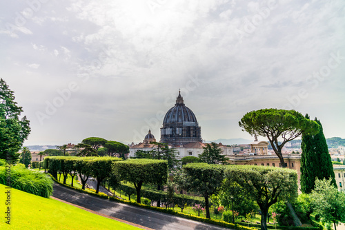 View of the dome of Saint Peter's Basilica in Rome seen from a garden