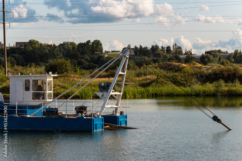 Dredge on water in a sand quarry, mining of nonmetallic materials photo