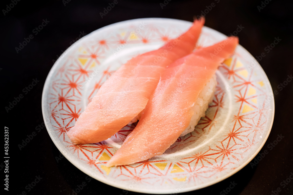 Sushi and Sashimi. Dishes of Sushi and Sashimi rolling on conveyer belt. Sushi and Sashimi. Dishes of Sushi and Sashimi rolling on conveyer belt.