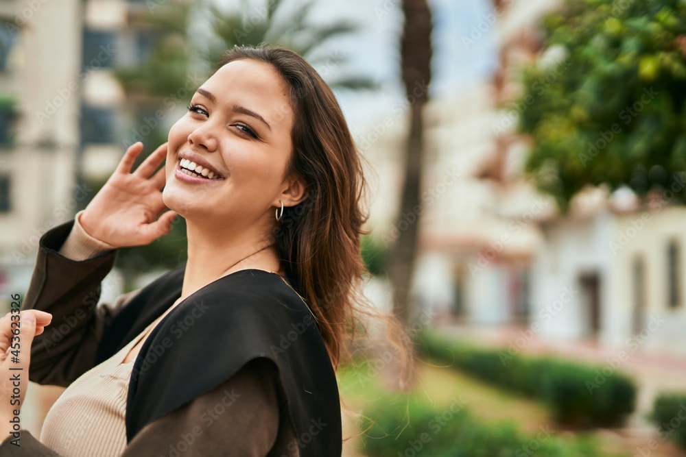 Young hispanic woman smiling happy standing at the city. Young hispanic woman smiling happy standing at the city.