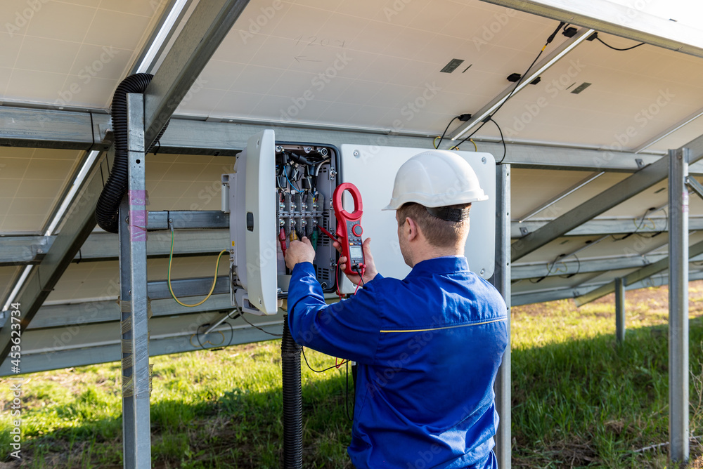 The inspector checks the actual output voltage level of inverter Stock ...