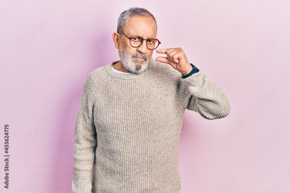 Handsome senior man with beard wearing casual sweater and glasses mouth and lips shut as zip with fingers. secret and silent, taboo talking Handsome senior man with beard wearing casual sweater and glasses mouth and lips shut as zip with fingers. secret and silent, taboo talking
