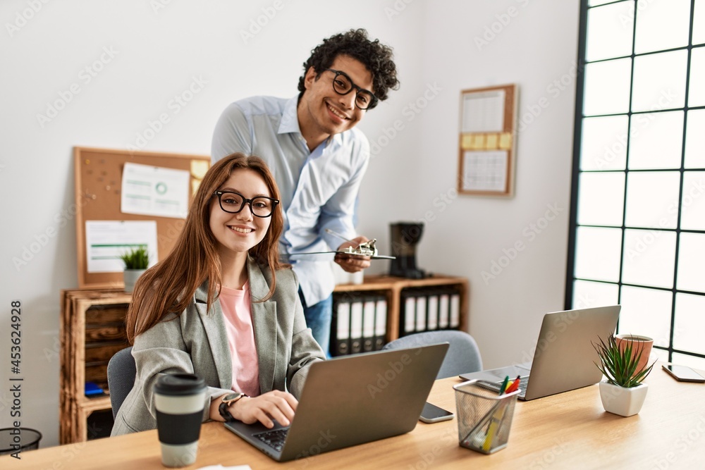 Two business workers smiling happy working at the office. Two business workers smiling happy working at the office.
