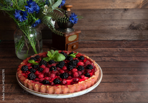 Tableau sur toile Tyrolean pie with fresh raspberries and blackberries on a wooden table