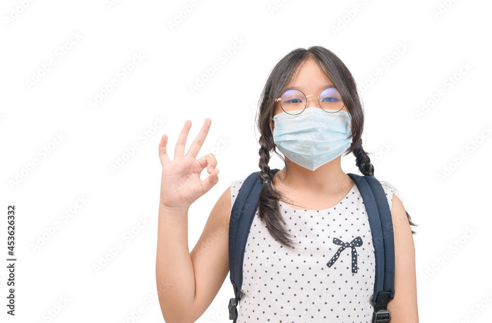 cute happy Asian student wear mask and show OK sign isolated on white. cute happy Asian student wear mask and show OK sign isolated on white.